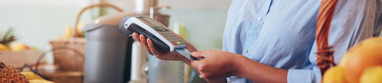 woman taking payment with card reader